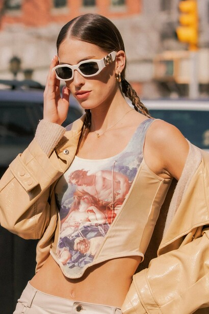 A fashion-forward street style look accented by Versace accessories, reflecting the house’s combination of glamour and empowerment