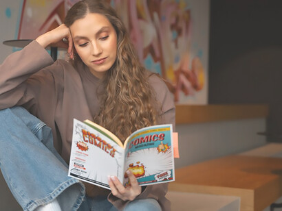 Engaged comic reader immersed in Marvel universe showcases graphic design innovation and cultural impact