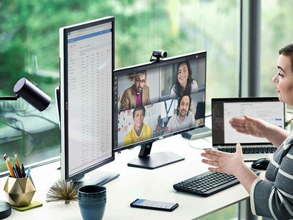 A woman conducting a zoom meeting from her home office