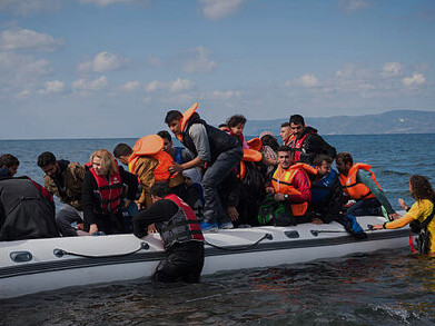 A refugee boat reaches the coast of Lesbos, Greece, highlighting the challenges of the migration crisis
