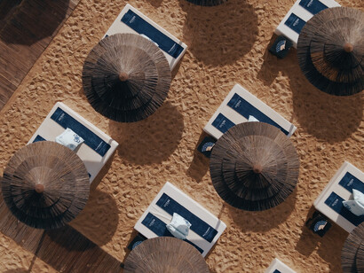 Phi Beach Club in Sardinia, created in collaboration with Guess, offering cliffside glamour and Mediterranean style