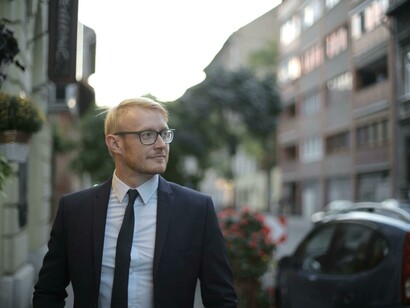 A man in suit celebrates a victory of his effort and dedication 