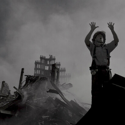 A firefighter in the rubble of a collapsed tower