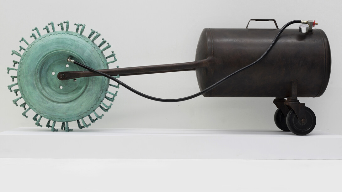 Tao Kulczycki, Wheel-barrow of life (Bhavacakra, cyclic existence), 2014, bronze (wheel-barrow tire, ear aids) green patina, steel (modified air tank), air hose and valve, 20.5 x 56 x 12 in.