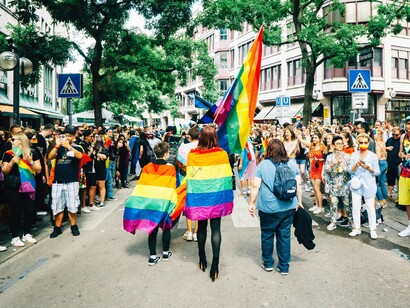Trans, gays, and lesbians draped in the rainbow flag as they demonstrate their pride