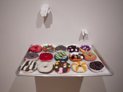 Eunkang Koh, Dreaming of Donuts, detail of installation, soft sculpture, trays and cast hands. Courtesy of Melhop Gallery°7077