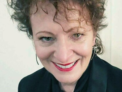 Nan Goldin renowned artist and activist smiling 