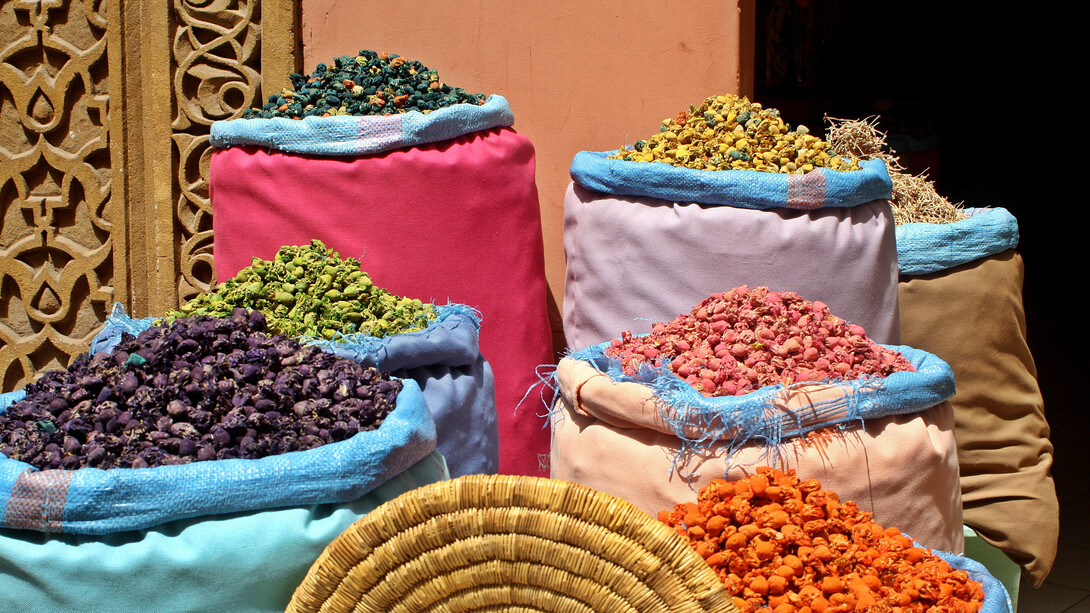 Rows of vibrant Moroccan spices fill the market stalls, offering a rich palette of flavors essential for creating traditional dishes like Rfissa