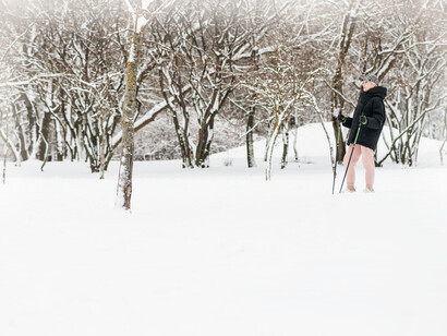 An older woman takes a walk to stay healthy, even in the snow