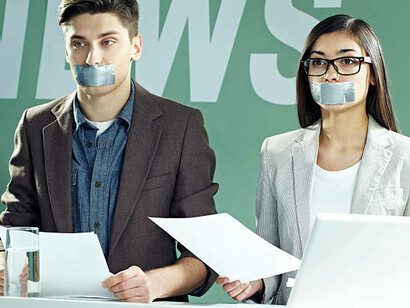 Two reporters with taped mouths symbolize the silencing effect of censorship in broadcast media