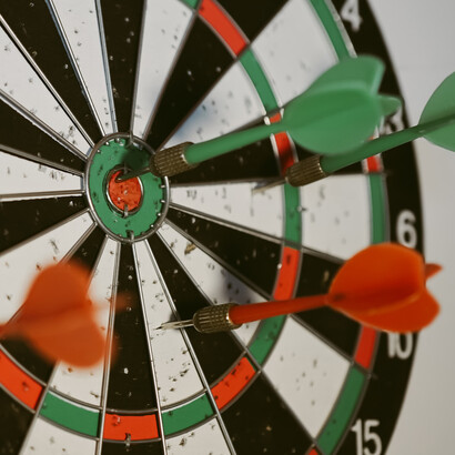 A dartboard with darts in the right places