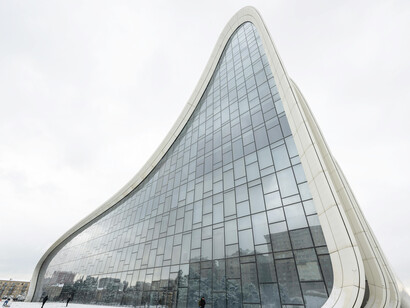 The snow-covered surroundings of the Heydar Aliyev Center accentuate the building's striking modern architecture in Baku, Azerbaijan