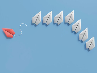 Discover the essence of individuality within a visually striking image of paper planes, where a bold red one distinguishes itself from the others, conveying a powerful message of uniqueness and separation