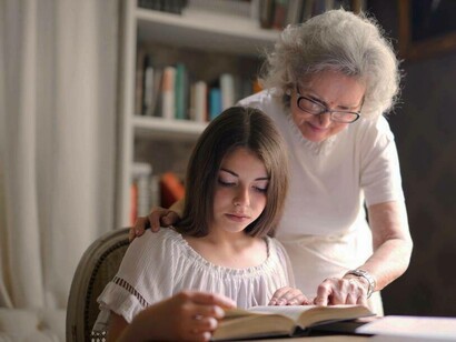 Grandmother reading with grand daughter