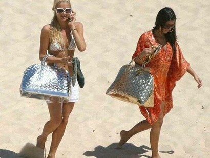 Paris Hilton and Kim Kardashian at the beach headed to their long chairs