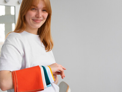 Featuring colorful fabric swatches, a woman illustrates how nanotechnology and silver nanoparticles create self-cleaning, antimicrobial clothing, paving the way for sustainable fashion solutions