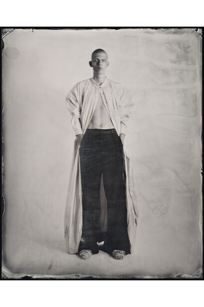 Kasia Wozniak, Wet Plate Collodion Ambrotype, Inspiration from the pages of Sherlock Holmes: “He was clad only in a pink dressing gown, which covered his night clothes. There were carpet slippers on his bare feet.” [The Hound of the Baskervilles by Arthur Conan Doyle], Fashion credits: Coat: Anna Bezgubenko, MA Fashion Design Technology Menswear, London College of Fashion, 2014; Trousers: Ed Lee, BA Menswear, Central Saint Martins, 2014; Slippers: Charlotte Chan, BA Fashion Design with Marketing, Central Saint Martins, 2014, © Kasia Wozniak/Museum of London