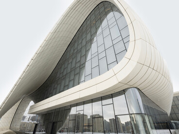 A winter view of the Heydar Aliyev Center in Baku, Azerbaijan, highlighting its distinctive curves and contemporary architectural style