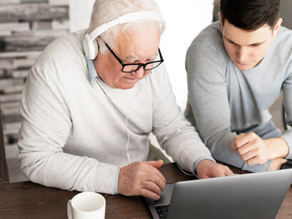 An elderly man exploring digital tools powered by AI to assist with dementia care