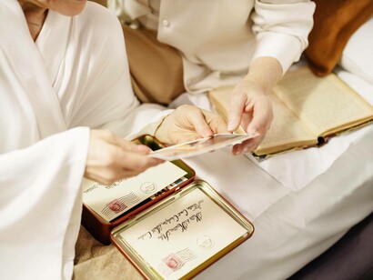 Two women looking at a container of old memories, letters and photos