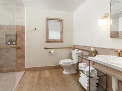 A clean, softly styled bathroom with warm, neutral tones