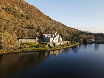 Castle at the foot of a mountain near lake, Ireland