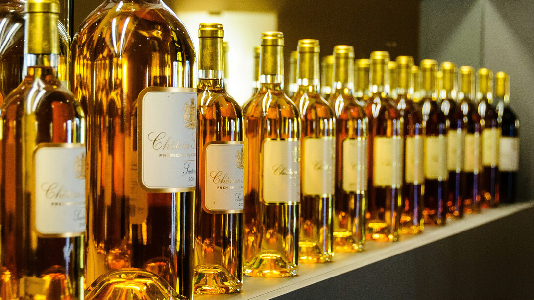 A row of wine bottles arranged neatly side by side