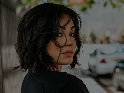 A woman looking back and questioning her surroundings in her peaceful society