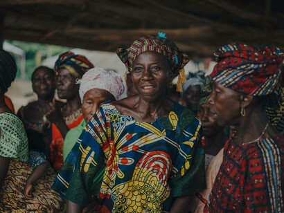 A group of African women in their traditional African garments is expressing their pride in their culture