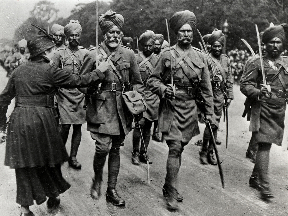 Stalwarts from the East, A French lady pins a flower on the Sikh saviours of France, Paris, 1916. (Source: Toor Collection)