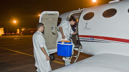 Organ transport team preparing to board an airplane