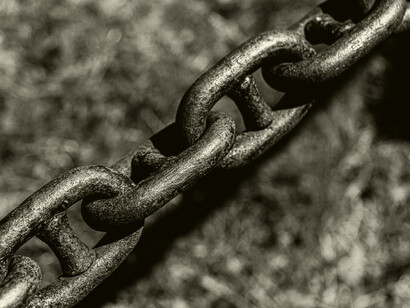 Interlocked metal links emphasize how deeply slavery was embedded in the nation’s economic and social systems, connecting industries, regions, and class structures