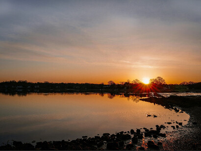 An emerging sunrise from a far showcasing a new dawn towards a society’s cultural way of living 