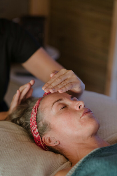 Reiki energy work brings calm and balance as a woman enjoys a deeply restorative healing experience