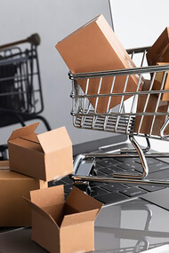 Online shopping epitomizes convenience culture, as illustrated by a mini trolley full of shopping boxes on a laptop, showcasing the impact of convenient lifestyles, technologies, and approaches