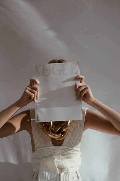 A person holding a magazine in front of their face. When is what you see what you see?