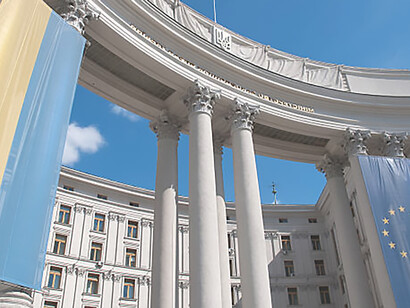 Experience the symbolic unity between Ukraine and the European Union with an image showcasing their flags flying proudly atop the Kiev Ministry of Foreign Affairs, exemplifying diplomatic relations and cooperation