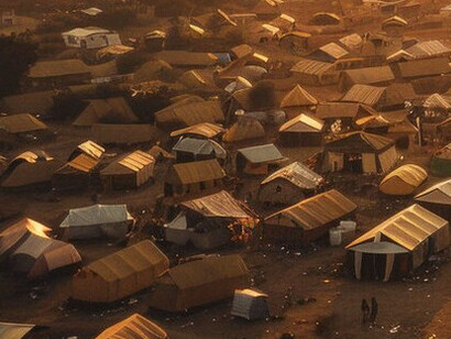 The stark contrast of a low-income African township reflects the deep-rooted disconnection between the people and the government institutions that are supposed to serve them, highlighting the dissociation from cultural values