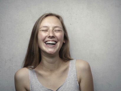 Young girl laughing with braces
