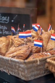 Baked pastries in a brown wicker basket, freshly prepared in Amsterdam, Netherlands