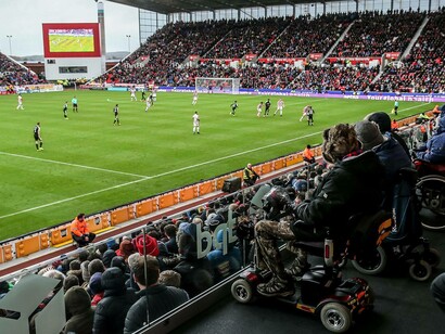Football supporters watching their team play at Stoke City FC in the designated handicapped zone