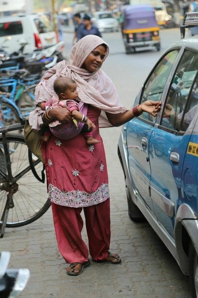 A woman, asking for money in India