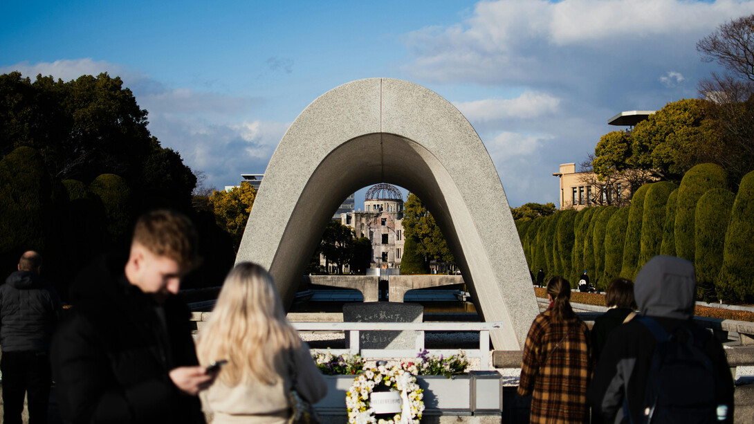 Visitors at the arch of Hiroshima Peace Memorial Park, Hiroshima, Japan