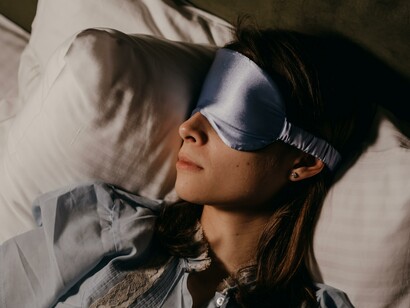 A woman wearing an eye mask whilst sleeping 
