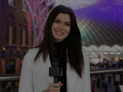 Cheerful journalist conducting an interview with a microphone