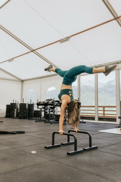 Woman balancing at the gym doing a handstand 