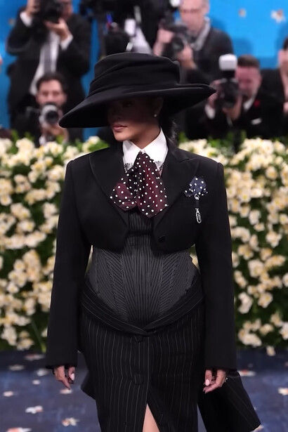 Rihanna in custom Marc Jacobs, wearing a pinstriped tailored ensemble with an oversized hat during the 2025 Met Gal