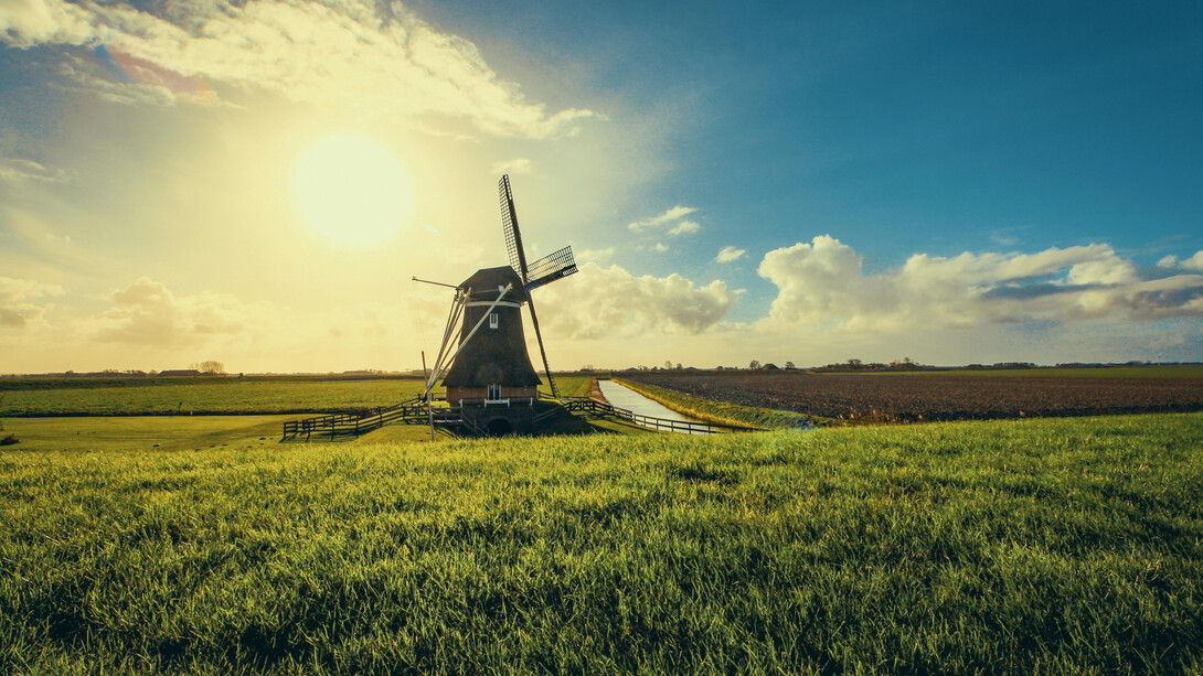 Vintage black windmill at sunset in Uithuizermeeden, Groningen, Netherlands 