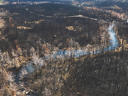 The aftermath of nature wildfires from an impactful aerial view, highlighting the urgent connection to climate change and the broader climate crisis, as we strive to comprehend and address the escalating environmental challenges