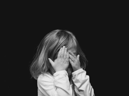 Bambina con le mani sugli occhi. Un tempo l’educazione impartita dai genitori ai propri figli era fondamentalmente basata sulla severità da parte dei genitori e obbedienza alle regole da parte dei figli